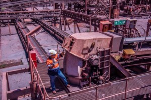A Weba Chute Systems field advisor inspects a bucket elevator transfer chute to verify optimal performance and reliability on site.