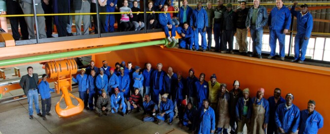 Condra staff pose within a giant crane manufactured in 2006 for Sishen, at the old Germiston factory.