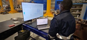 Quality inspector Obby Kangwa takes measurements with advanced equipment used at the SupremeServ facility in Jet Park.